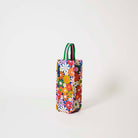 Our Coastal Floral Wine Bag, a tall narrow bottle bag in a retro daisy print of orange, red, pink, yellow and white flowers on a navy background, with a single green and pink striped carry handle.