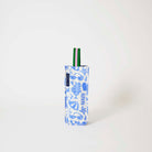 Our Feast Wine Bag, a tall narrow bottle bag in an ecru base with a blue seaside print of sunglasses, ice cream sundaes, beach umbrellas, starfish and sardines, with a single green and pink striped carry handle.