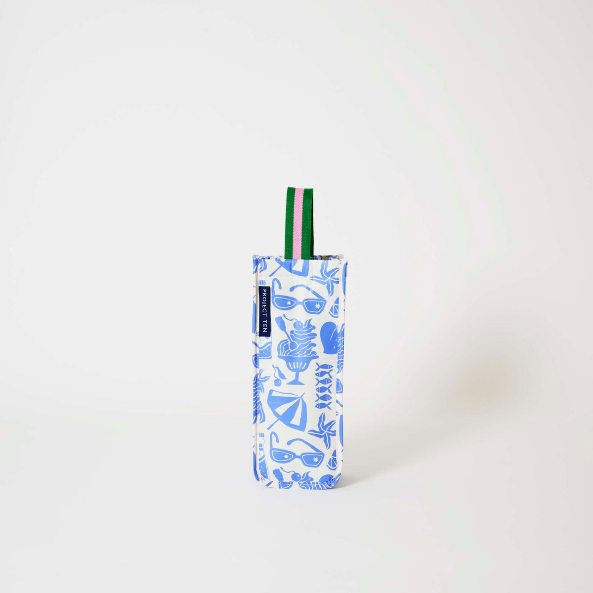 Our Feast Wine Bag, a tall narrow bottle bag in an ecru base with a blue seaside print of sunglasses, ice cream sundaes, beach umbrellas, starfish and sardines, with a single green and pink striped carry handle.
