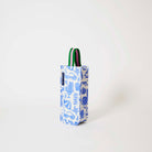 Our Feast Wine Bag, a tall narrow bottle bag in an ecru base with a blue seaside print of sunglasses, ice cream sundaes, beach umbrellas, starfish and sardines, with a single green and pink striped carry handle.
