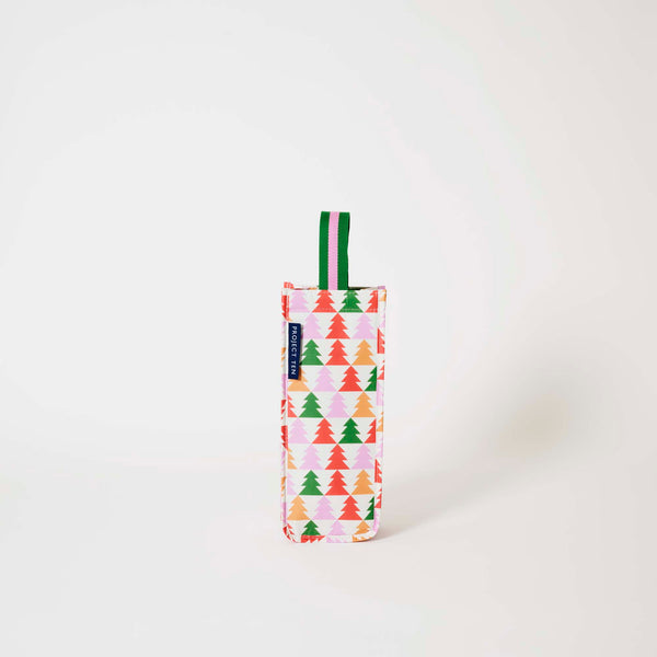 Our Holiday Cheers Wine Bag, a tall narrow bottle bag in an ecru base with a repeating geometric Christmas tree print in red, green, pink and orange, with a single green and pink striped carry handle.
