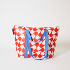 Our Red Ripple Zip Medium Tote in a red and ecru wave print, with a full zip closure across the top and long blue shoulder straps.