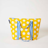 Our Yellow Polka Dot Zip Medium Tote in bright yellow with ecru polka dots, with a full zip closure across the top and long blue and ecru striped shoulder straps.
